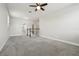 Spacious, carpeted living room with white trim, a staircase, and lots of light at 8433 Corkfield Ave, Orlando, FL 32832