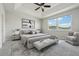 Serene main bedroom with tray ceiling, neutral tones, and comfortable furnishings bathed in natural light at 8433 Corkfield Ave, Orlando, FL 32832