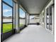 View of the covered, screened patio with view of the yard, fence, and other homes at 8433 Corkfield Ave, Orlando, FL 32832