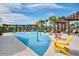 Gathering-friendly community splashpad with lounge chairs and palm trees in background at 8433 Corkfield Ave, Orlando, FL 32832