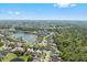 Picturesque aerial view showcasing a lakefront community with mature trees and landscaping at 848 Jadestone Cir, Orlando, FL 32828