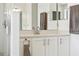 Bathroom vanity featuring white cabinets, countertop, modern fixtures, and decorative mirror at 848 Jadestone Cir, Orlando, FL 32828