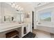 Beautiful bathroom with double vanities, large mirror, soaking tub, and sleek fixtures at 848 Jadestone Cir, Orlando, FL 32828