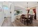 Elegant dining room with hardwood floors, table with seating, and seamless transition into the living room at 848 Jadestone Cir, Orlando, FL 32828