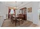 Well-lit dining room featuring hardwood floors, and a wooden table with seating for six at 848 Jadestone Cir, Orlando, FL 32828