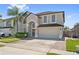 Inviting two-story home with a well-manicured lawn and attached two car garage at 848 Jadestone Cir, Orlando, FL 32828