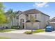 Beautiful home with a two-car garage, lovely landscaping, and a blue car in the driveway at 848 Jadestone Cir, Orlando, FL 32828