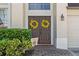 Inviting entryway with double doors, decorative wreaths, and mature landscaping at 848 Jadestone Cir, Orlando, FL 32828