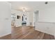 Bright hallway with wood floors connects to a bedroom and bathroom with elegant white trim and fixtures at 848 Jadestone Cir, Orlando, FL 32828