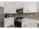 Bright kitchen featuring stainless steel appliances, white cabinets, and gray backsplash at 848 Jadestone Cir, Orlando, FL 32828