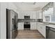 Clean kitchen with stainless steel appliances, white cabinets and countertops, and modern fixtures at 848 Jadestone Cir, Orlando, FL 32828