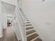 Wooden staircase with white railings leading to the upper floor of the home at 848 Jadestone Cir, Orlando, FL 32828