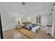 Bright bedroom with natural light, featuring a queen-sized bed, decorative lamps, and light hardwood floors at 851 Georgia Ave, Winter Park, FL 32789