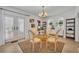 Bright dining room featuring French doors, an elegant chandelier, and a round glass-top table with a striking leopard print rug at 851 Georgia Ave, Winter Park, FL 32789