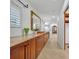 Bright hallway featuring light wood floors, built-in wooden drawers, and an ornate gold mirror at 851 Georgia Ave, Winter Park, FL 32789