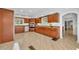 Well-lit kitchen featuring wooden cabinets, stainless steel appliances, light wood floors, and a charming breakfast nook at 851 Georgia Ave, Winter Park, FL 32789