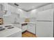 Efficient kitchen with white cabinetry, white appliances, and ample counter space at 851 Georgia Ave, Winter Park, FL 32789