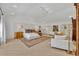 Expansive main bedroom featuring light wood floors, stylish seating, elegant decor, and modern lighting at 851 Georgia Ave, Winter Park, FL 32789