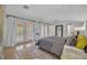 Light-filled main bedroom with wood floors, French doors, and ensuite bathroom access at 851 Georgia Ave, Winter Park, FL 32789