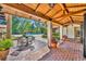 Charming outdoor patio with a wooden beamed ceiling, a dining table, and a view of the pool at 851 Georgia Ave, Winter Park, FL 32789