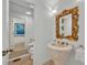 Unique powder room featuring a decorative gold mirror and a marble cone sink at 851 Georgia Ave, Winter Park, FL 32789