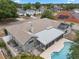 Back aerial view of home showing screened lanai, pool, fenced yard, and patio area with pergola at 8520 Rose Groves Rd, Orlando, FL 32818