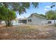 Home featuring a large backyard with mature shade trees and an in-ground pool at 8520 Rose Groves Rd, Orlando, FL 32818
