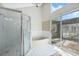 Bright bathroom features a shower, tub, and sliding doors to a private patio at 8520 Rose Groves Rd, Orlando, FL 32818
