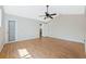 Spacious bedroom features hardwood floors, neutral paint, and a ceiling fan at 8520 Rose Groves Rd, Orlando, FL 32818