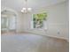 Bright dining room with neutral carpet and elegant chandelier at 8520 Rose Groves Rd, Orlando, FL 32818