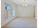 Bright dining room with neutral carpet and elegant chandelier at 8520 Rose Groves Rd, Orlando, FL 32818