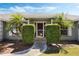 Close-up of front entrance with palm trees and manicured hedges lining the walkway at 8520 Rose Groves Rd, Orlando, FL 32818