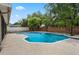 A beautiful pool with privacy fence and lush tropical landscaping at 8520 Rose Groves Rd, Orlando, FL 32818