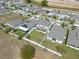 Community aerial view shows houses with solar panels and fenced yards at 885 Carmillion Ct, Groveland, FL 34736