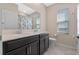 Bathroom with dual sinks, large mirror, and tiled floor at 885 Carmillion Ct, Groveland, FL 34736