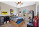 Bright bedroom features ceiling fan, window, and colorful decorations at 885 Carmillion Ct, Groveland, FL 34736