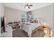 Bedroom with ceiling fan, window, and bookcase at 885 Carmillion Ct, Groveland, FL 34736