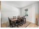 Bright dining room with a dark wood table, six chairs, and natural light at 885 Carmillion Ct, Groveland, FL 34736