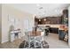 Modern kitchen with dark cabinets, stainless steel appliances and adjacent dining space at 885 Carmillion Ct, Groveland, FL 34736