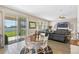 Cozy living room featuring a ceiling fan, slider to back yard and plush sectional sofa at 885 Carmillion Ct, Groveland, FL 34736