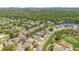 Wide aerial perspective showcasing home's location near a golf course and a beautiful lake at 10027 Hart Branch Cir, Orlando, FL 32832