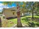 Backyard view showcasing a palm tree, green lawn, and white picket fence surrounding the property at 10027 Hart Branch Cir, Orlando, FL 32832