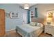 Comfortable bedroom with light blue walls, a fabric headboard, and coordinated decorative accents at 10027 Hart Branch Cir, Orlando, FL 32832