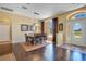 Elegant dining room with hardwood floors, modern lighting, and a large window providing natural light at 10027 Hart Branch Cir, Orlando, FL 32832