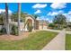 A beautiful home with a well-manicured lawn, mature palm trees, and a two-car garage adds curb appeal at 10027 Hart Branch Cir, Orlando, FL 32832