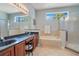 Ensuite bathroom with a double vanity, bathtub, a separate glass-enclosed shower, and tiled floor at 10027 Hart Branch Cir, Orlando, FL 32832