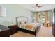 Serene primary bedroom with a ceiling fan, carpet, and a sunlit window with backyard views at 10027 Hart Branch Cir, Orlando, FL 32832