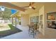 Covered patio featuring a ceiling fan and an outdoor dining area, perfect for relaxation and entertaining at 10027 Hart Branch Cir, Orlando, FL 32832