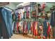 Organized walk-in closet with ample hanging space and shelving for clothing and accessories at 10027 Hart Branch Cir, Orlando, FL 32832