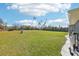 Expansive green backyard with a well, treeline and view of neighboring homes at 10367 Sw 45Th Ave, Ocala, FL 34476